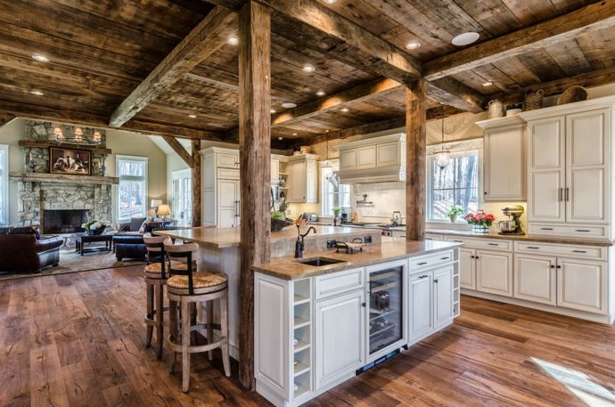 Wooden ceiling Wooden beams Wooden floor Stone fireplace Marble panels Recessed spotlights White rustic home furniture Kitchen
