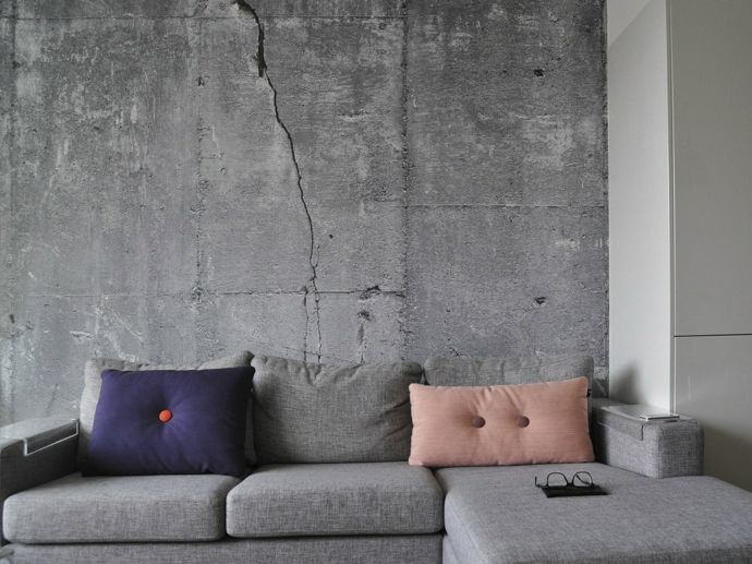 Living room sofa corner sofa decorative cushions purple pink gray wallpaper in concrete look industrial style