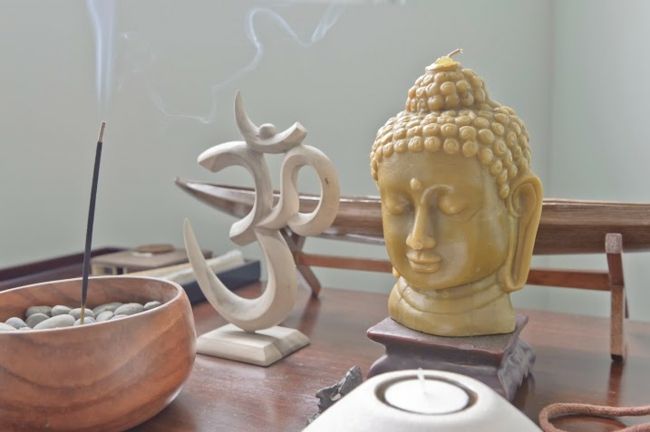 Buddha figure, OM, incense sticks, yoga room, candle