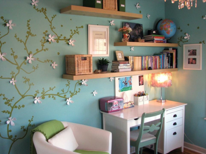 Colorful interior and small desk in white teenage girl's bedroom