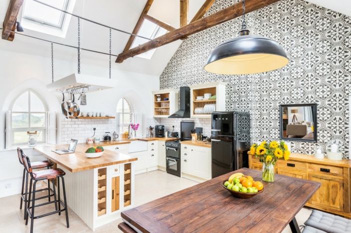 The table tops and worktops match the retained former rafter roof cement tiles in a rustic rustic style