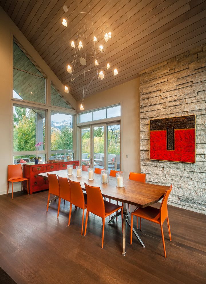 Furnishing of the dining room in warm colors-stone veneer interior design dining room orange red sloping roof