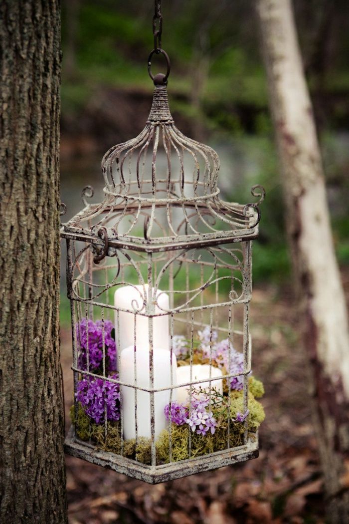 Elegant flower design for your garden-Set a wonderful accent with flowers and candles-Birdcage Garden garden design hanging pot tapered candles lilac blossom moss