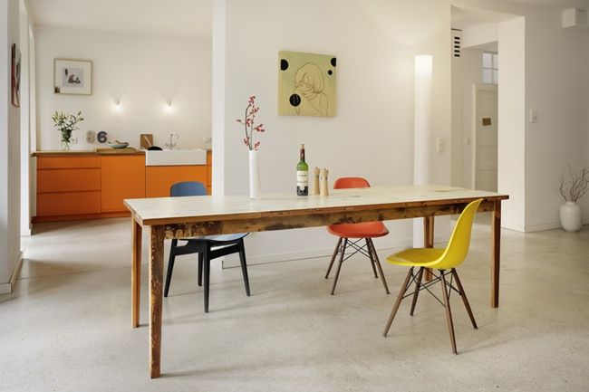 Dining room, furniture in orange, colorful chairs, a lot of room furnishing trends