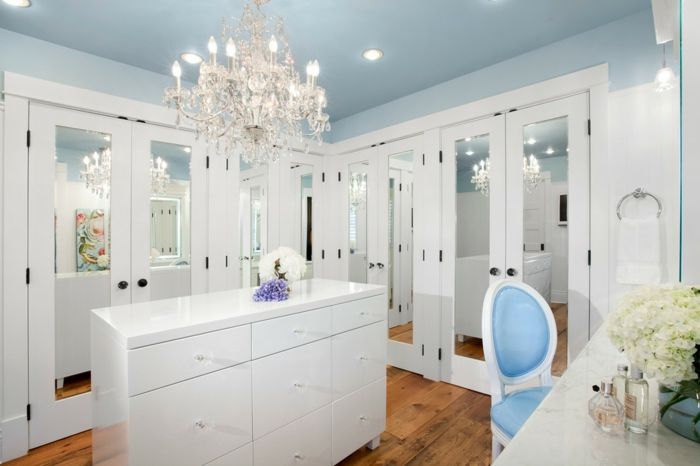 Feminine dressing room with dressing table-open walk-in closet system chest of drawers chandelier white luxury