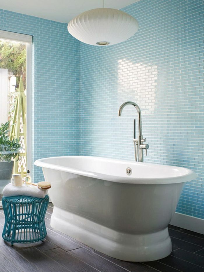 Tiled wall in light blue freestanding bathtub