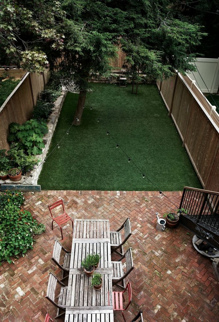 Backyard with floor tiles and artificial turf- The owner also takes care of her own lemon tree backyard Townhouse Family home New York entertainment area