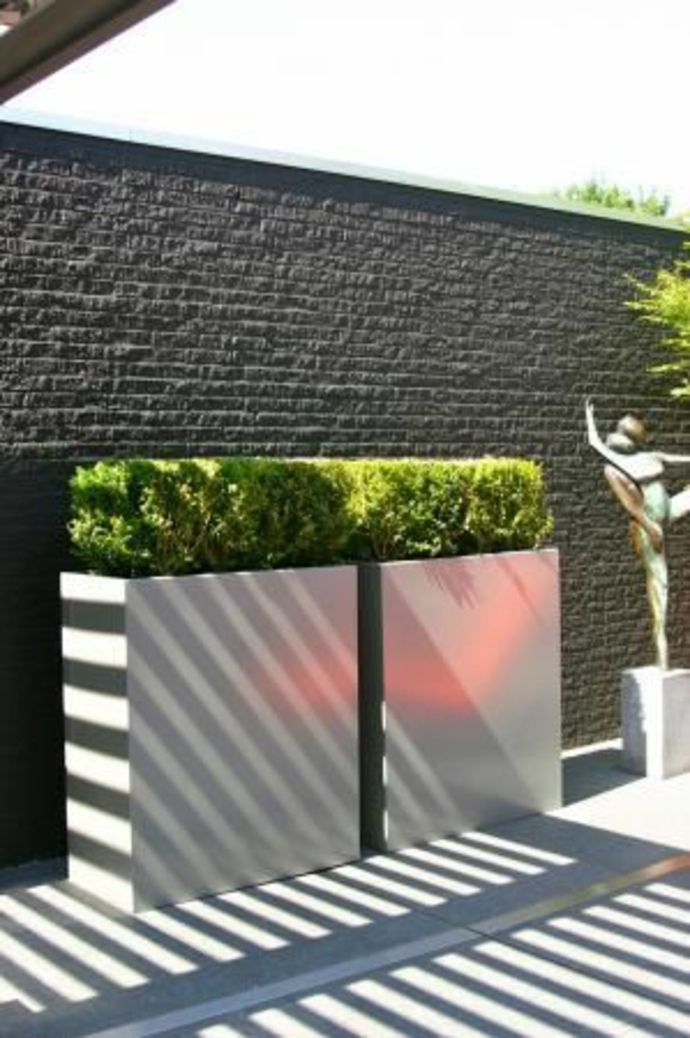 Concrete planter and partition wall in a minimalist garden landscape in a minimalist style