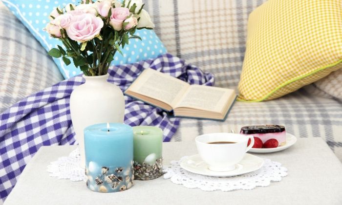 Create a retreat with a book, candles, flowers and delicacies-Who doesn’t like to be pampered on the sofa -Decoration Furnishing living room Sofa Checkered textiles Tapered candles Cut flowers in vase