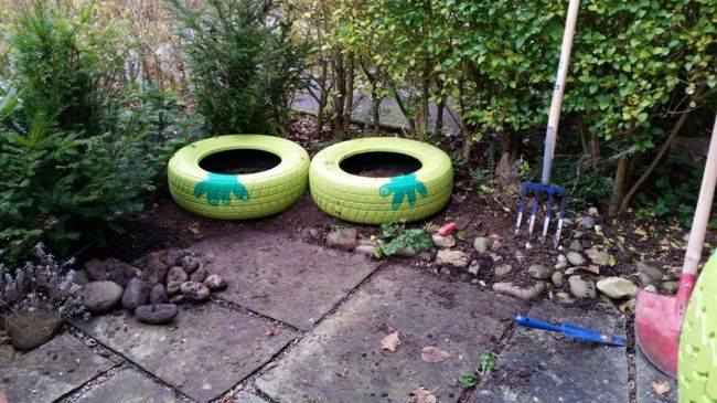 used car tires in bright colors as a flower pot garden decoration - ideas
