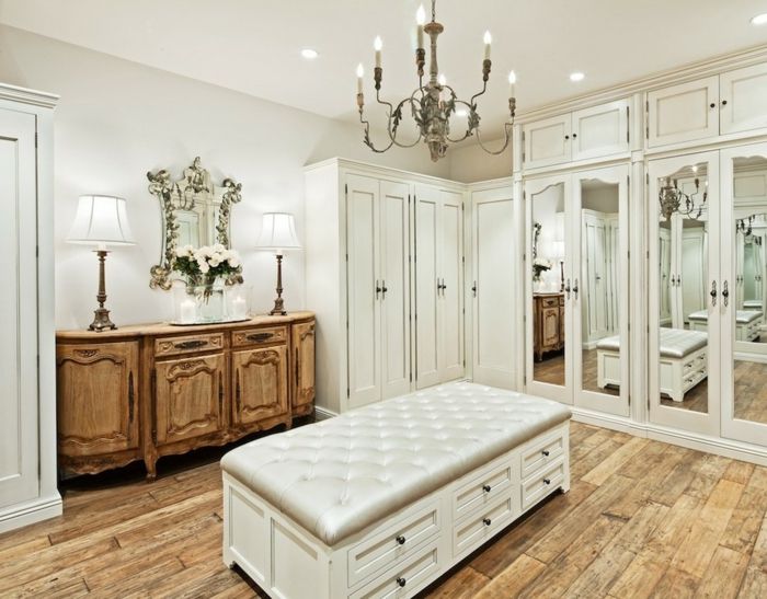 Lush furnishings in the dressing room-the chandelier gives the room a romantic look-open walk-in closet system luxury dressing room