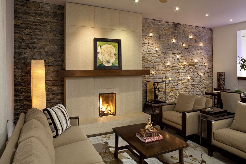 Lush design of the living room stone look stone wall interior design wall candle holder lighting fireplace living room furnishings