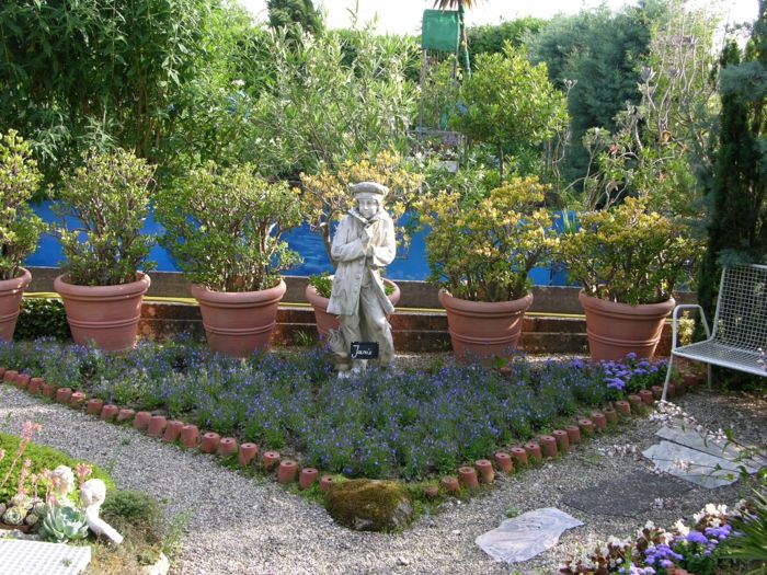 Flower bed border with clay pots and gravel