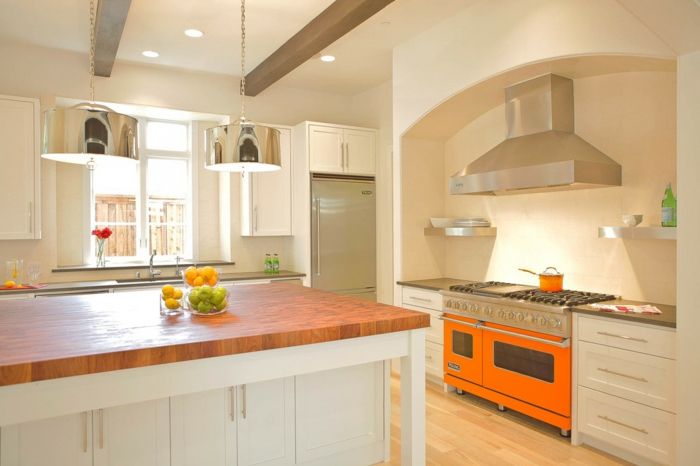 Modern kitchen with bright splashes of color and wooden worktops-modern kitchen worktops wooden island cooker hood metal