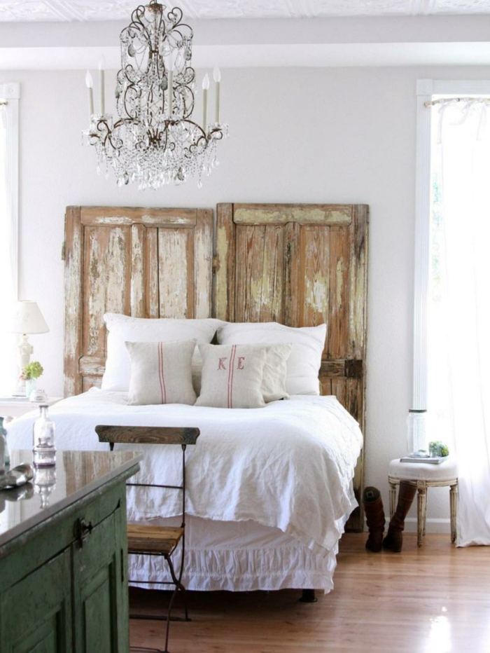 Bedroom idea with a headboard made of doors and a chandelier in a shabby chic style idea for living