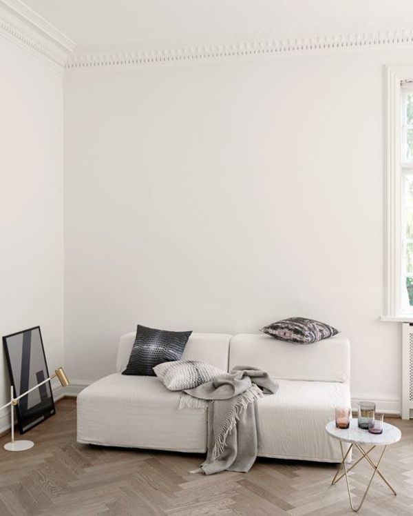 Living room white sofa minimal laminate flooring herringbone pattern
