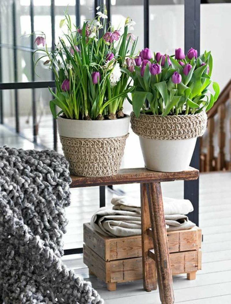 Spring flowers in beautiful pots are an eye-catcher in the living room