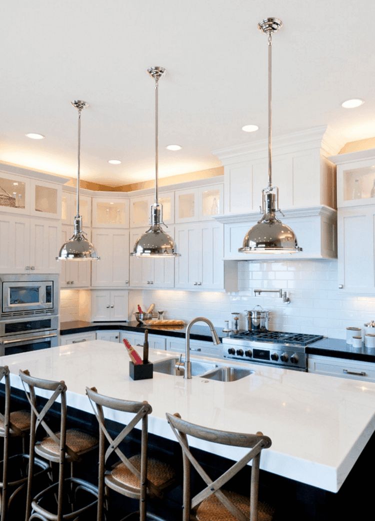Upper cabinet lighting optically accentuates the kitchen area