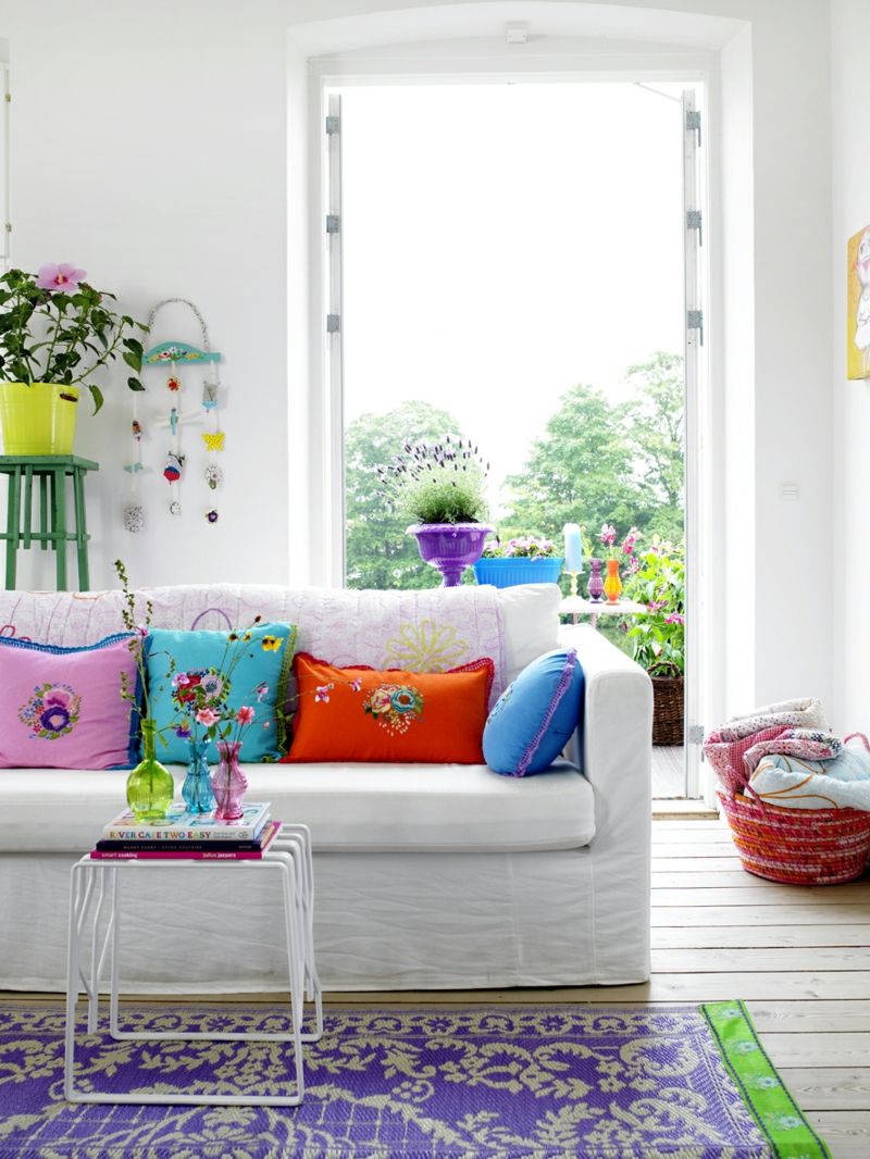 Colorful throw pillows and carpets spread a good spring mood in the living room