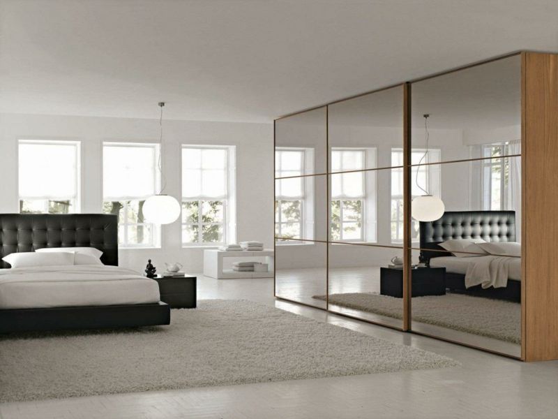 The floor-to-ceiling mirror cabinet makes the room appear larger