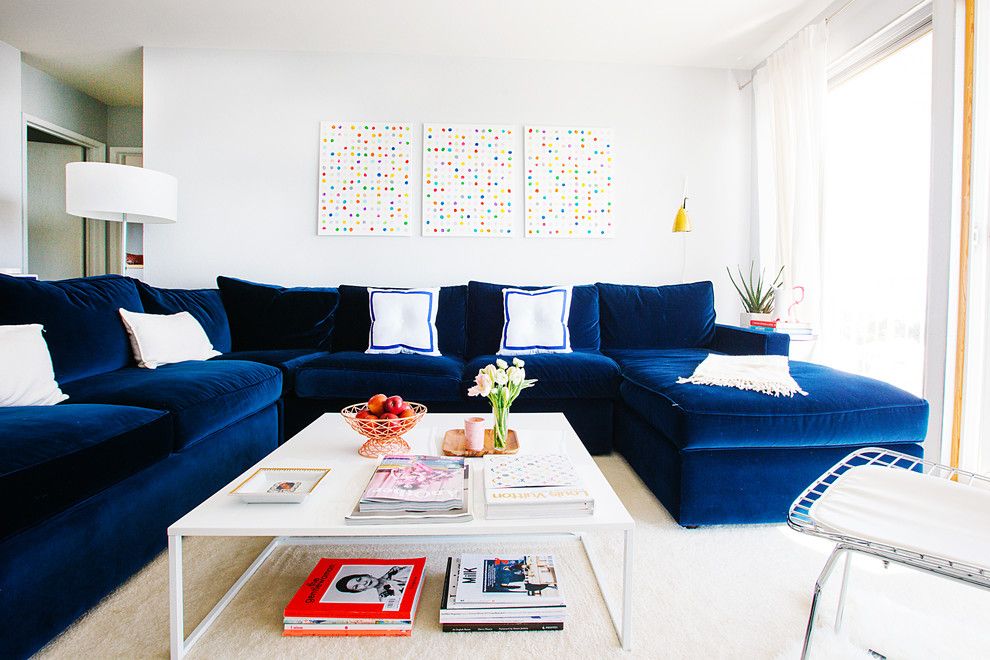 A dark blue sofa is the noble accent in the room