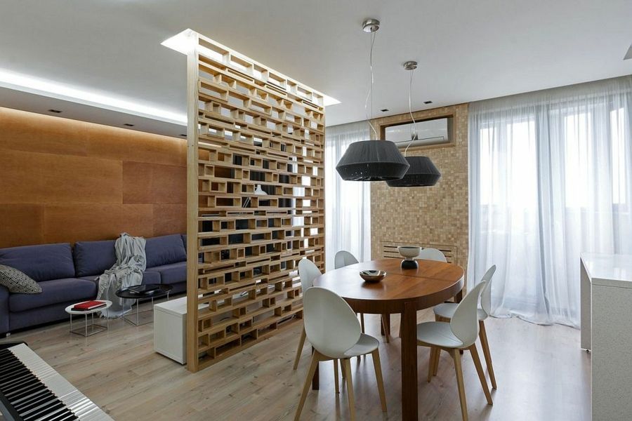 A great wooden shelf separates the living area from the dining area