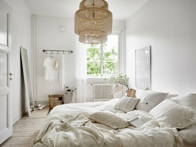 The color of the bed linen is in keeping with the white ambience