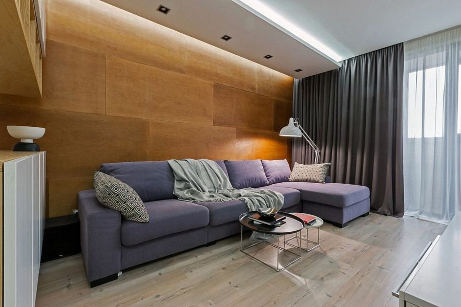 The gray textiles can be ideally combined with the wooden wall