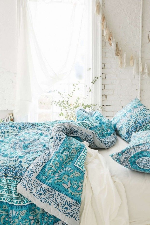 Ethnic pattern bed linen in sky blue and white bohemian bedroom