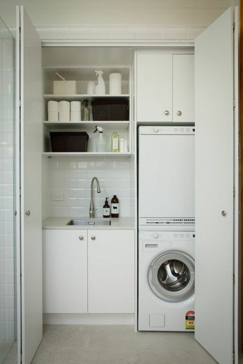 small laundry room in white harmonica doors