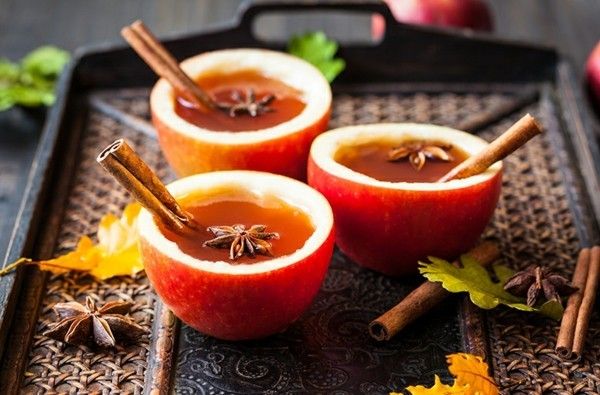 Apple-must-with-cinnamon-sticks-with-anise-star-in-eye-catching-cups-served-from-hollow-out-apples