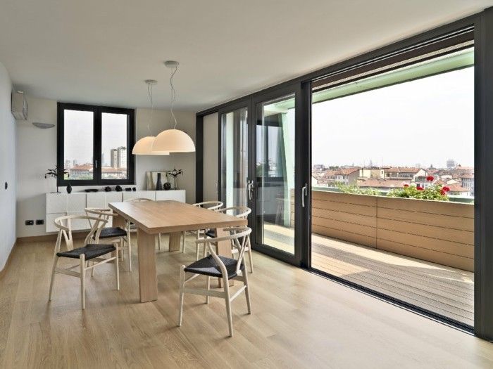 wooden-dining-table-and-elegant-chairs-in-the-dining-room-on-the-attic-with-a-wonderful-panoramic-view-of-the-city