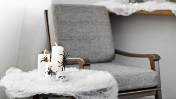 gray-upholstered-armchair-with-wise-halloween-decoration-next to it