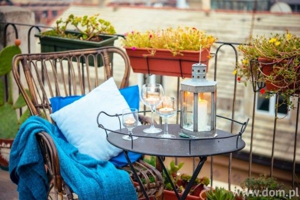 wonderful-terraces-with-cozy-touches-comfortable-rattan-chair-and-candles-on-the-wrought-iron table