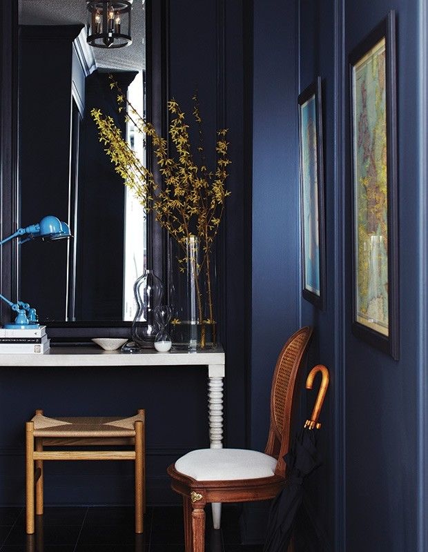 dark-blue-wall-light-blue-reading-lamp-wood-yellow-twigs-in-vase