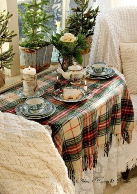 rustic-table-decoration-with-green-twigs-cones-and-candles