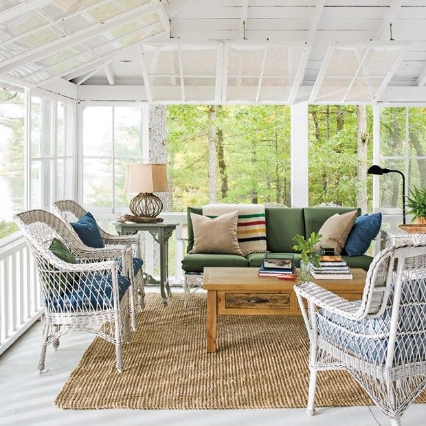 Covered-veranda-garden-furniture-wicker-armchairs-white-couch-decorative-cushions