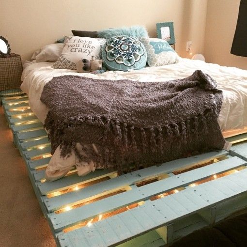 Bed made of pallets built-in lighting romance in the bedroom