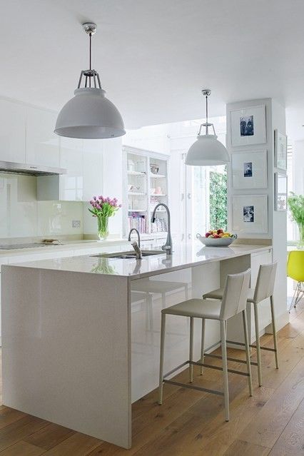 Country-style kitchen is created by a beautiful white kitchen island
