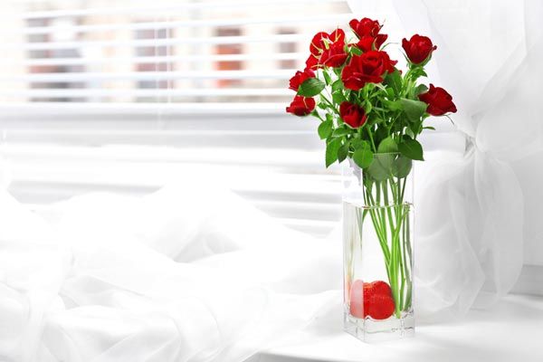 Vintage vases of red roses