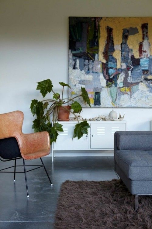 Ideen für Betonboden tolle Kombination mit Ledersessel Wandbild Teppich Zimmerpflanze