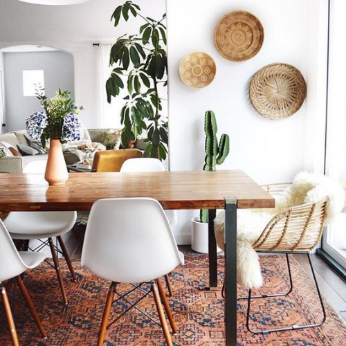 Boho chic in the dining room wall plates green house plants faux fur must-haves large dining table plastic chairs