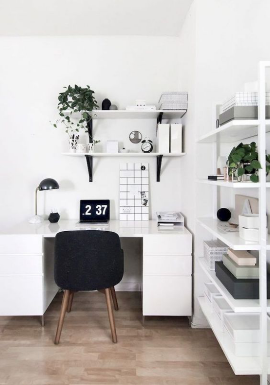 Farben fürs Heimbüro minimalistisch eingerichtetes Homeoffice in Weiß schwarze Akzente Lampe Stuhl Uhr grüne Zimmerpflanzen