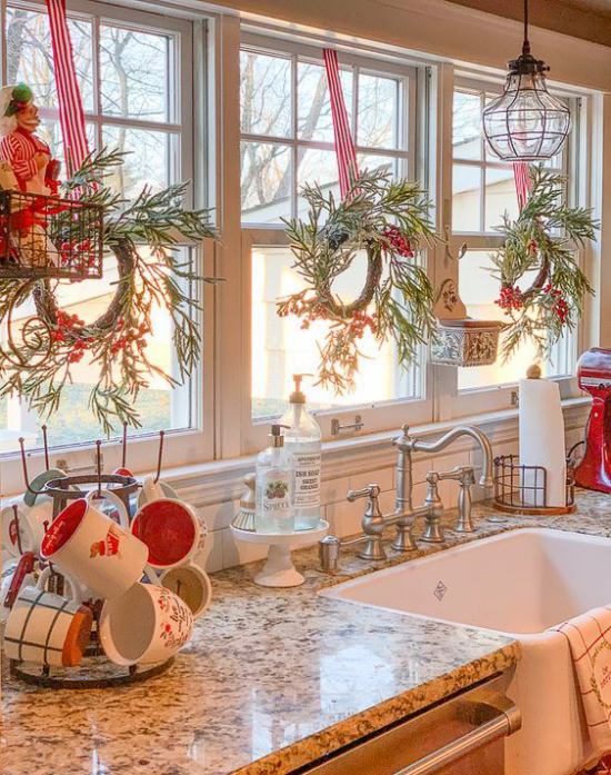 Küche zu Weihnachten schmücken grüne Kränze am Fenster Tassen in rot und weiß gemütliche Atmosphäre