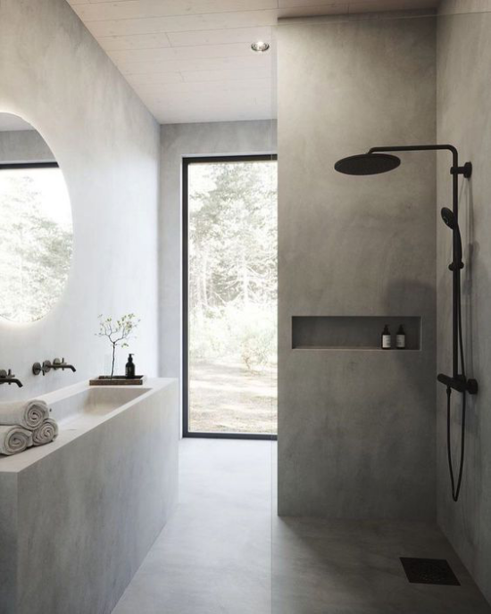 Moderne Badezimmer im minimalistischen Stil mit Touches in Industrial Style Betongrau schwarze Armaturen runder Spiegel Schiebetür zum Hinterhof