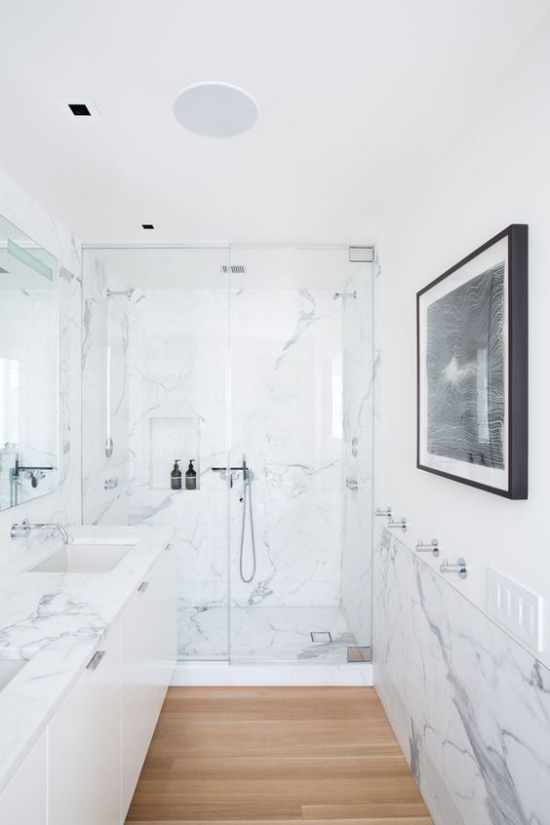 Moderne Badezimmer im minimalistischen Stil weißer Marmor Bodenfliesen in Holzoptik Dusch Glaswand Waschtisch links
