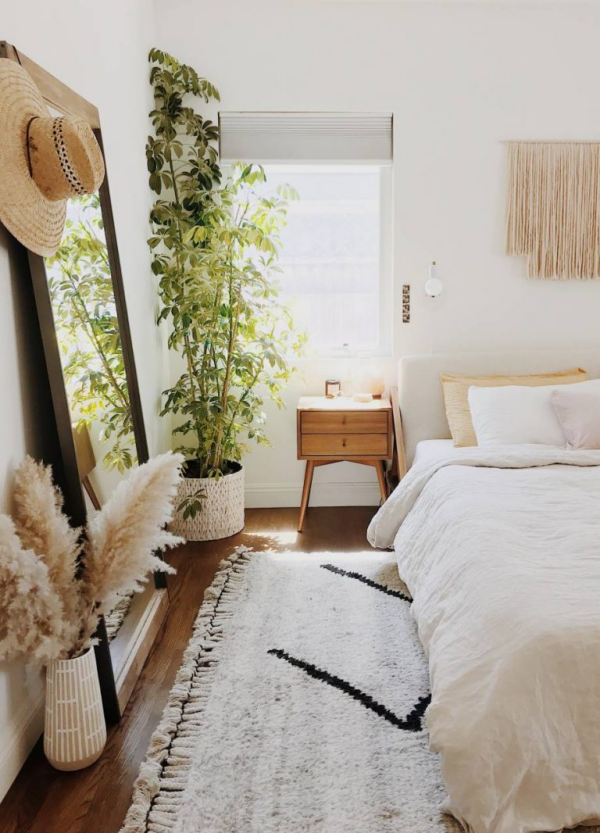 Pampasgras dekorieren Schlafzimmer in Boho Style weiche weiße Textilien eine grüne Topfpflanze