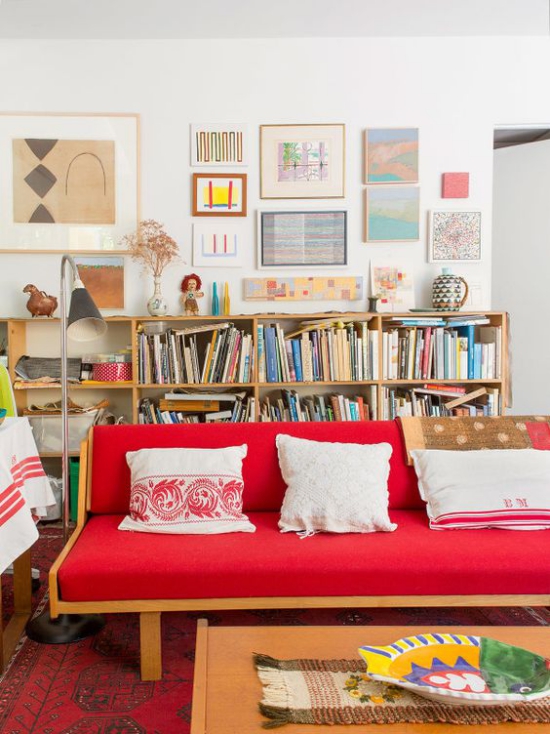 Rotes Sofa ein Jugendzimmer schreibt sich perfekt ein Regal viele Bücher