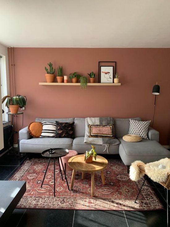 Rosa Akzentwand Wohnzimmer Regal grune Zimmerpflanzen naturliche Note Perser Teppich