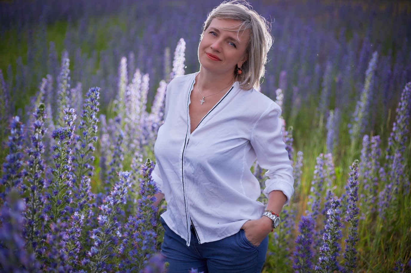 Frauenmode 202122 junge Frau hellblaue Bluse mit Volants im Lavendelfeld